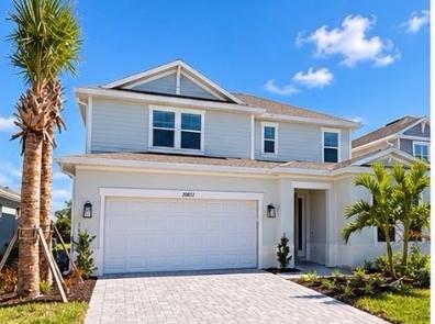 Front exterior of the two-story Montauk at 10851 Eclipse Street, with palm trees and a paver driveway